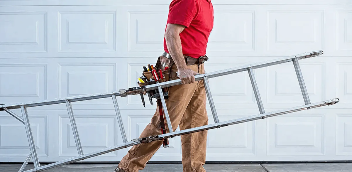 Garage door repair technician arriving with tools and ladder in Marietta, GA