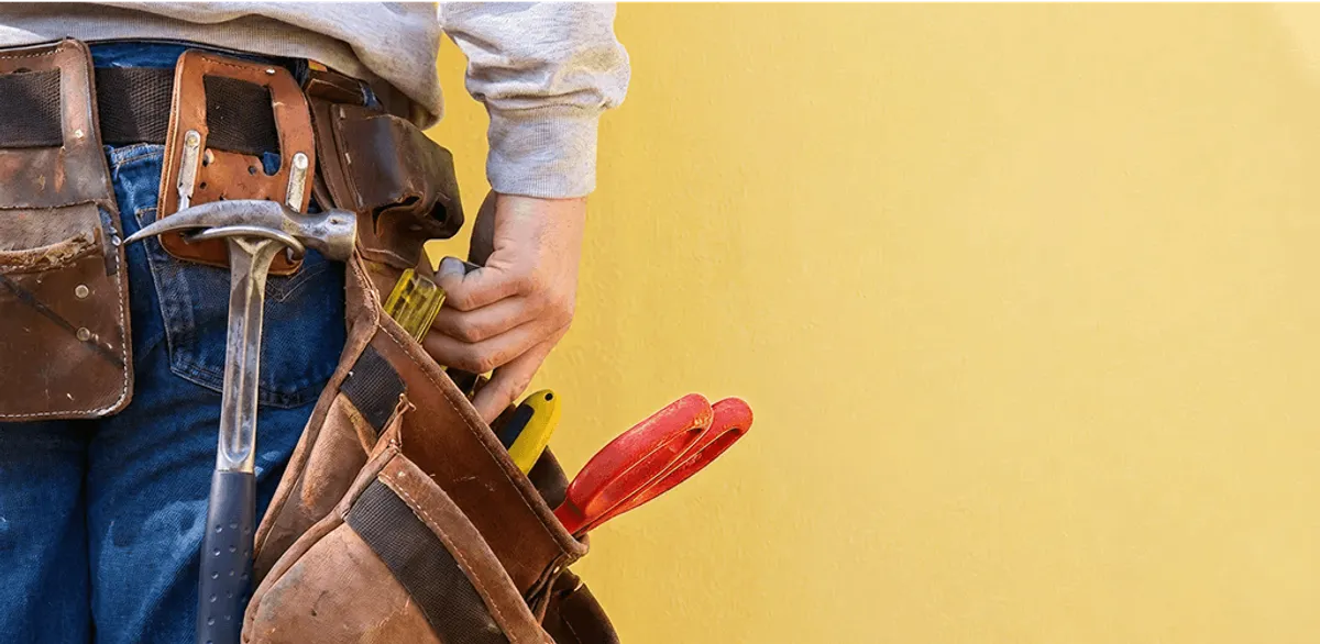 Handyman with tool belt ready for home repairs and maintenance in Marietta, GA